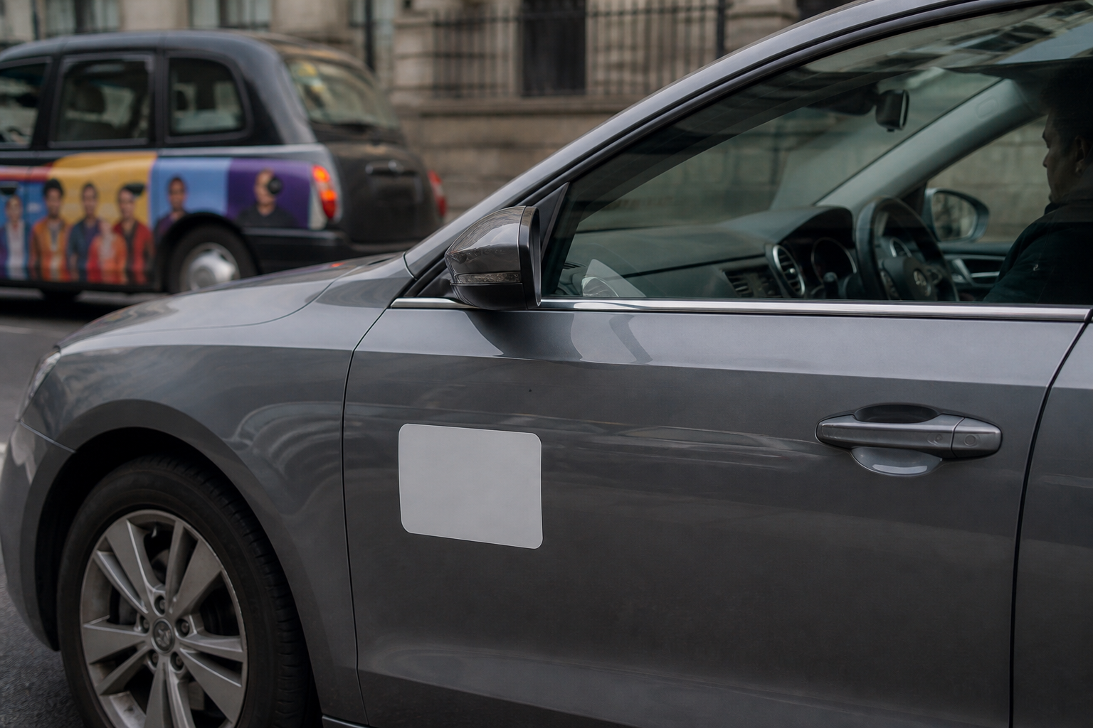 Side of a London private hire car with official operator sticker.